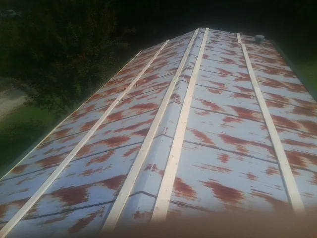 Rusted metal roof panels with new wood purlins before replacement — Storm Damage Roof Repair in Redkey by Roofing Brothers